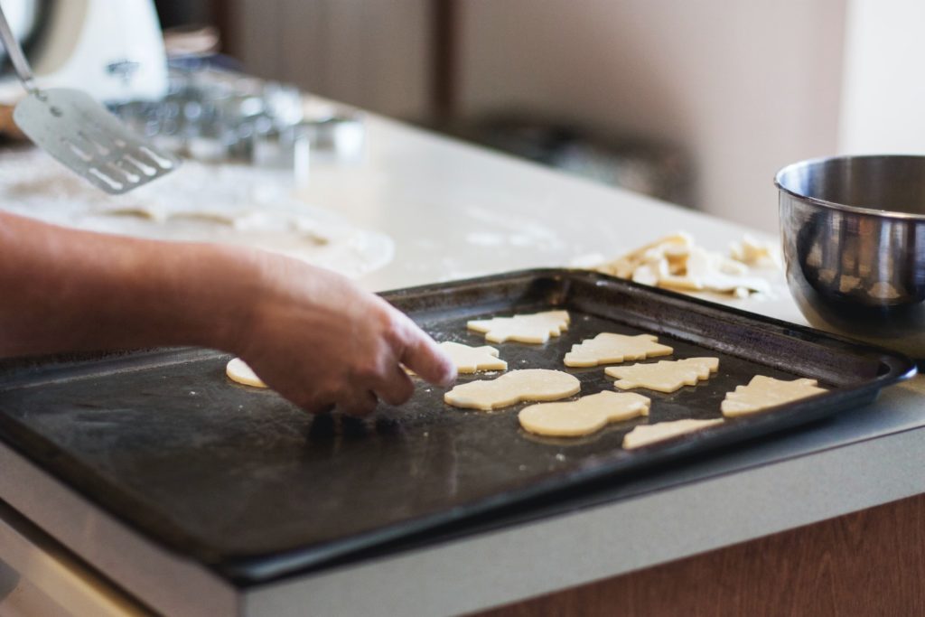 a person cutting up food on a grill