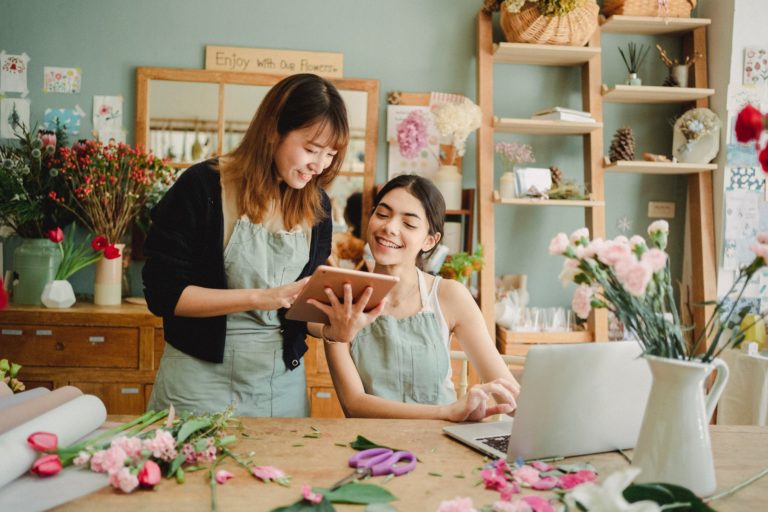 a woman and a girl looking at a laptop