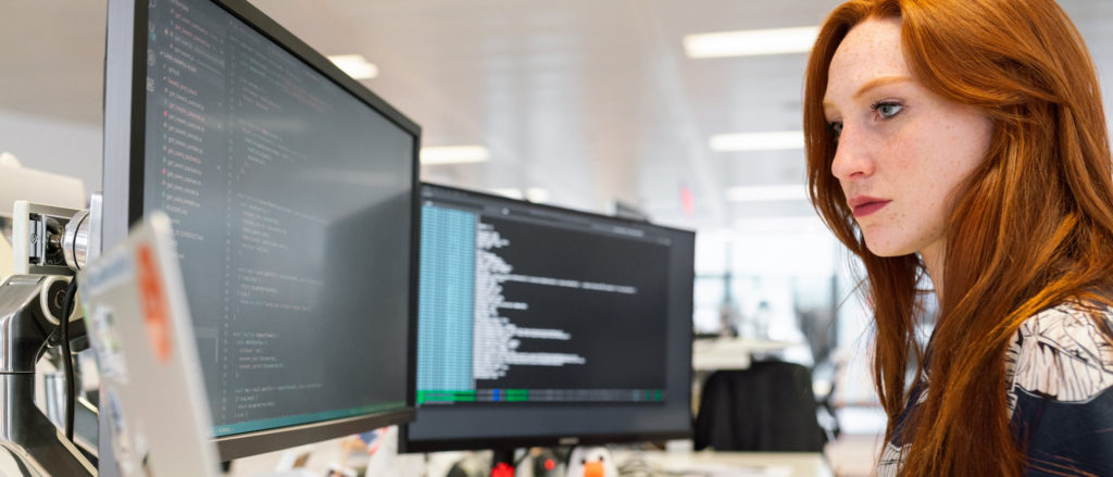 a woman looking at a computer screen