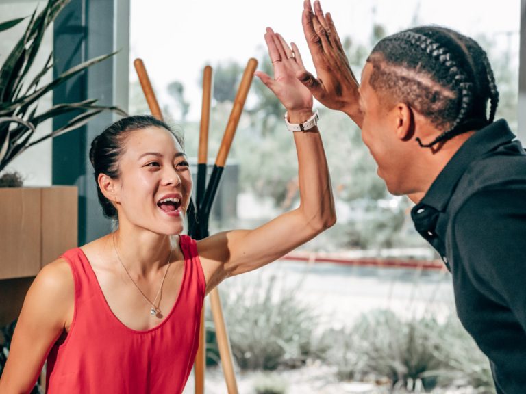 a man and a woman holding sticks