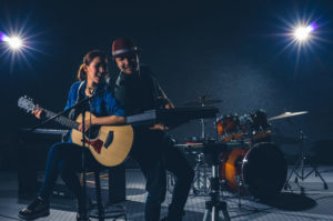 Musician duo band singing a song and playing music instrument with Fellow band musicians