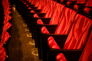 red colored seats in a movie theatre with no person